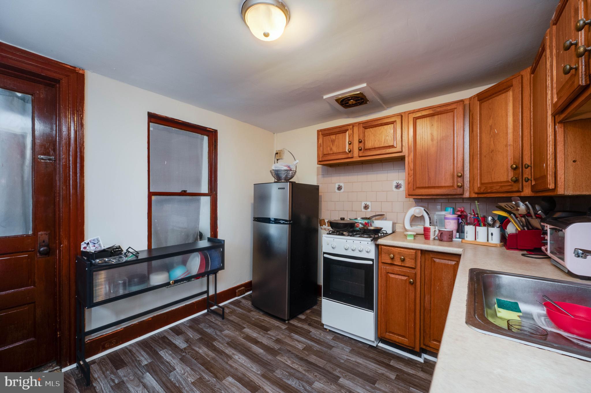 1032 North 5th Street Reading, PA 19601 - Photo 22 of 45 a kitchen with stainless steel appliances granite countertop a refrigerator stove and sink