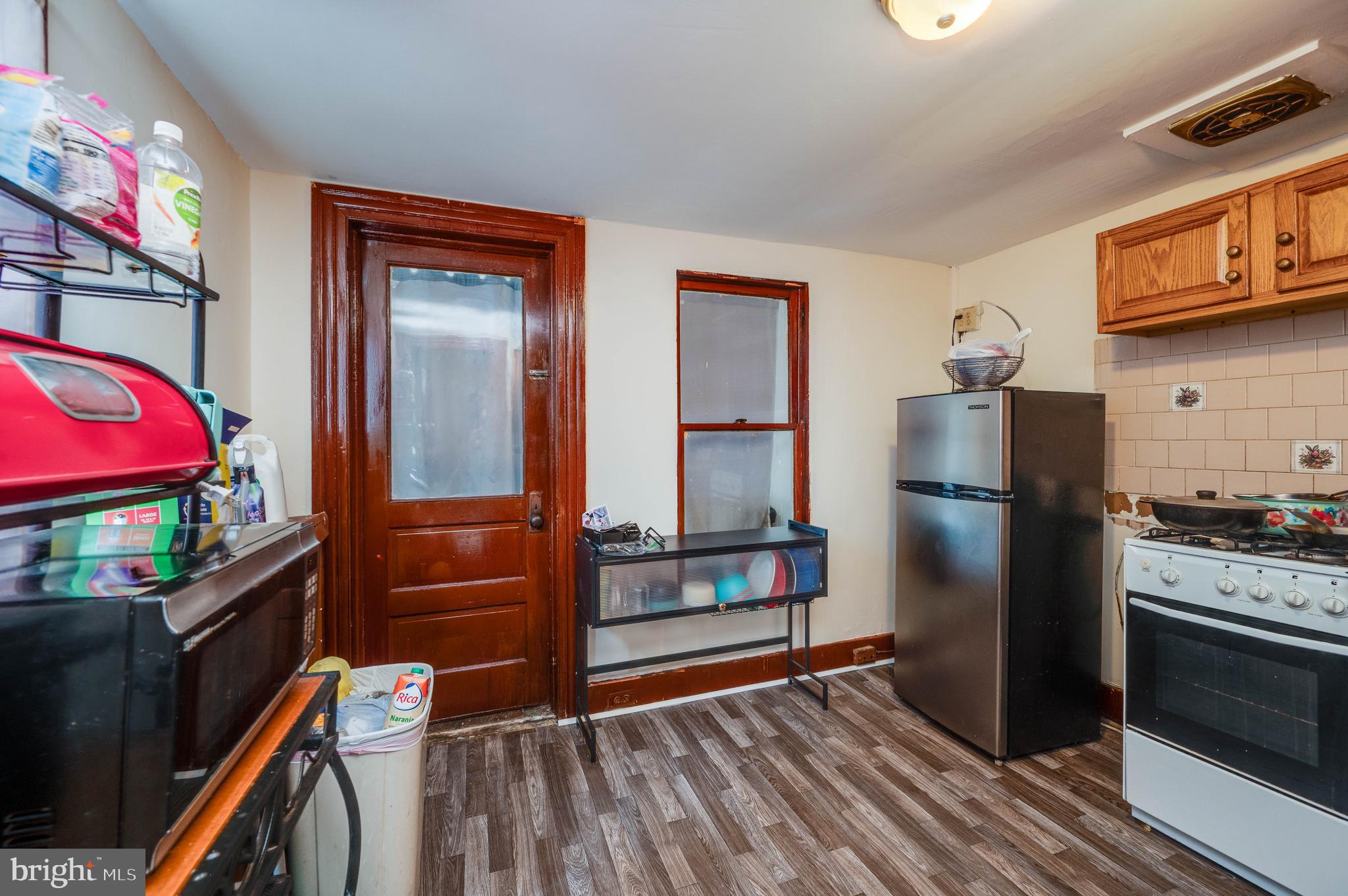 1032 North 5th Street Reading, PA 19601 - Photo 23 of 45 a kitchen with stainless steel appliances granite countertop a refrigerator and a stove top oven