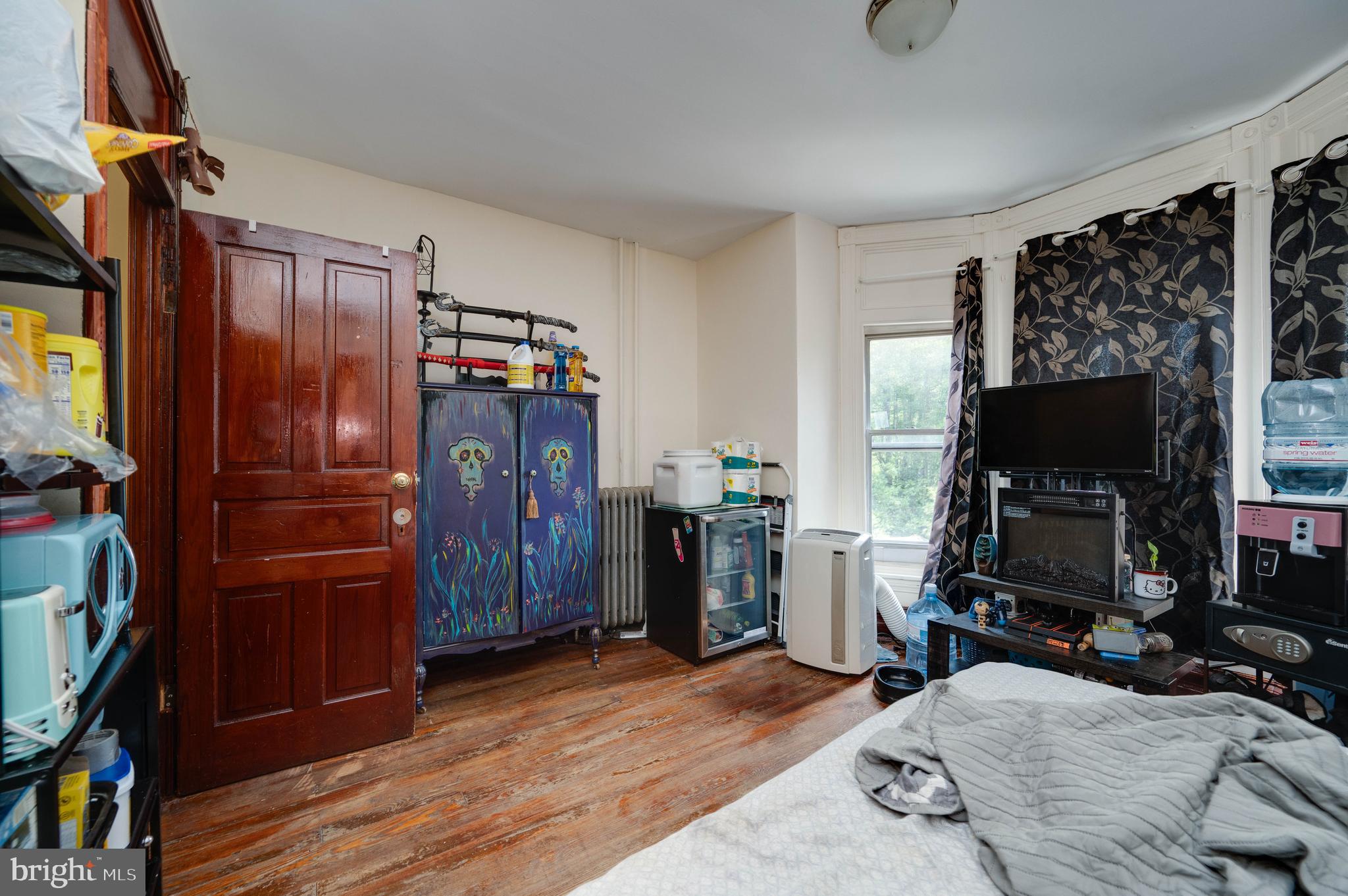 1032 North 5th Street Reading, PA 19601 - Photo 29 of 45 a bedroom with a bed and a flat tv screen