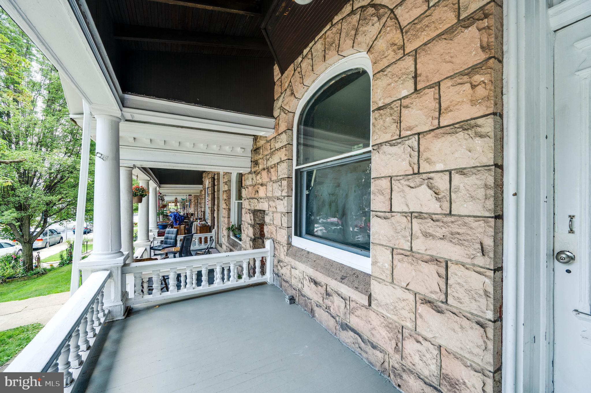 1032 North 5th Street Reading, PA 19601 - Photo 3 of 45 a view of a porch with wooden floor and fence