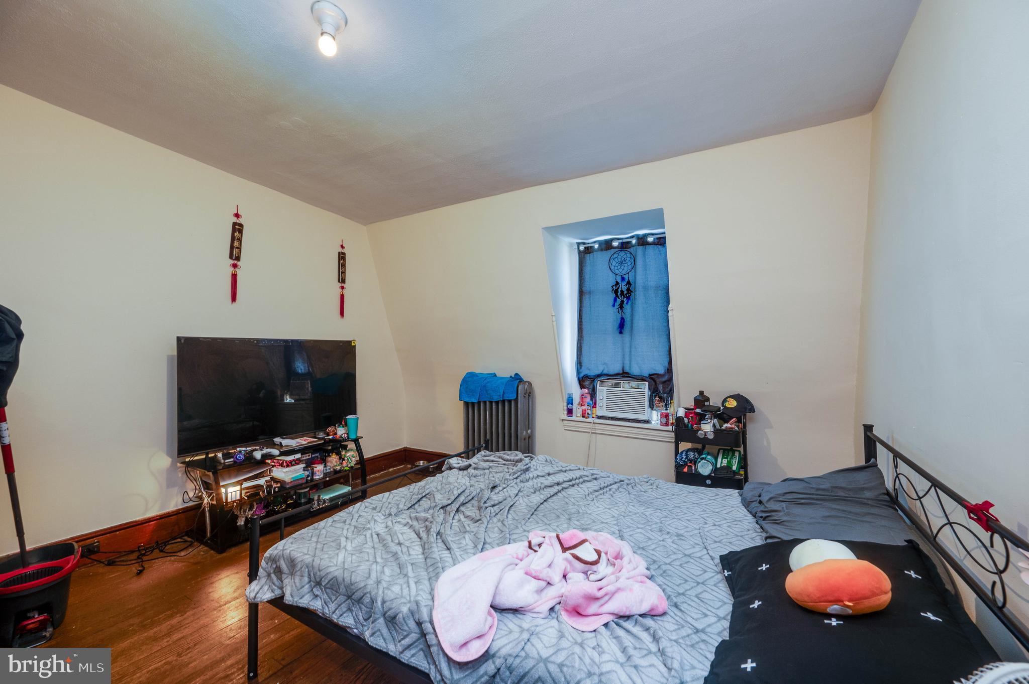 1032 North 5th Street Reading, PA 19601 - Photo 37 of 45 a bedroom with bed and a flat screen tv