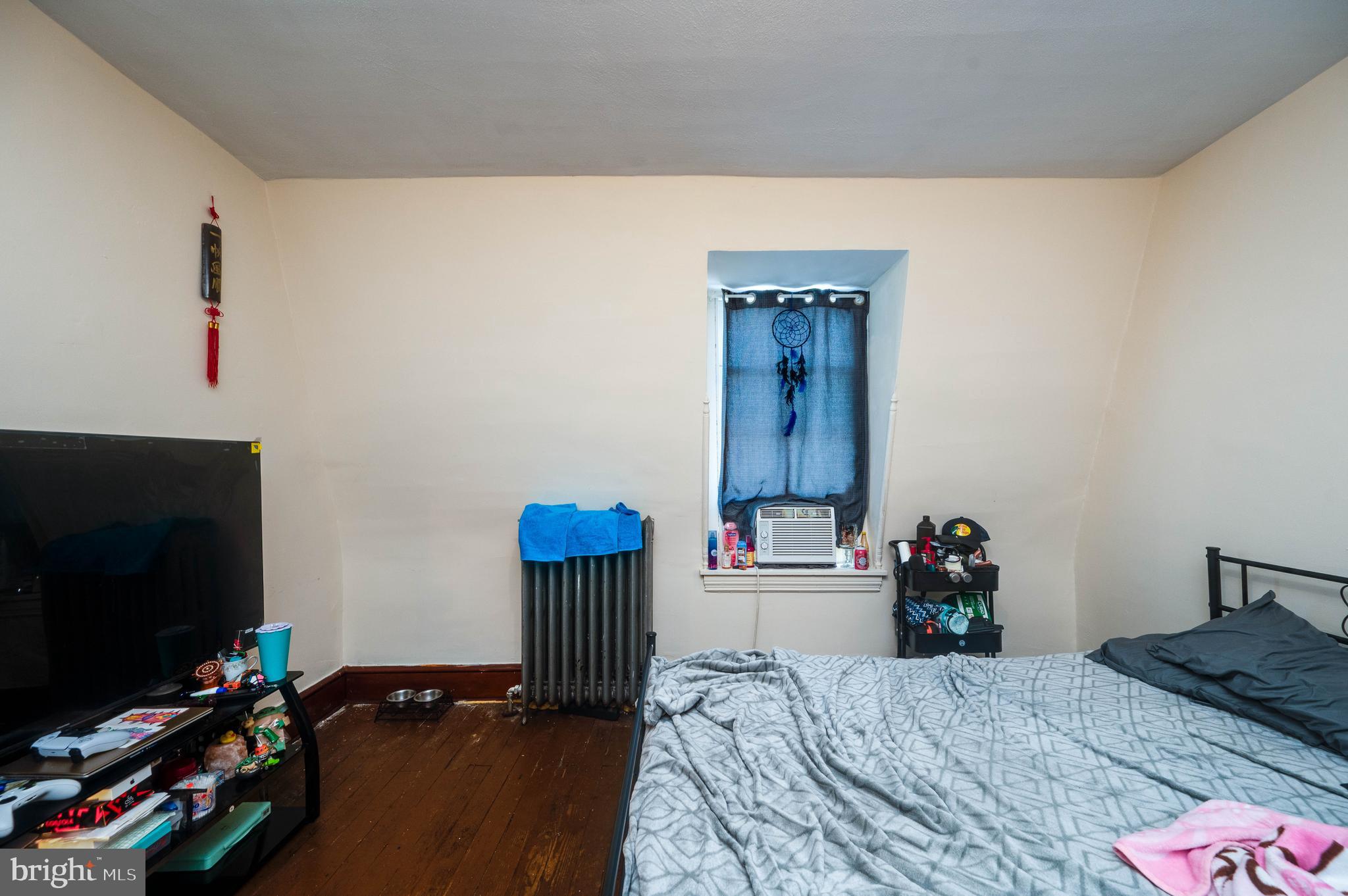 1032 North 5th Street Reading, PA 19601 - Photo 38 of 45 a bedroom with a bed and a flat screen tv