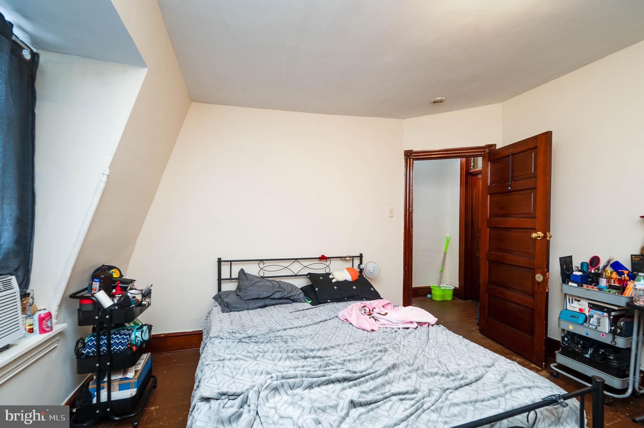 1032 North 5th Street Reading, PA 19601 - Photo 39 of 45 a bedroom with a bed a flat screen tv and furniture
