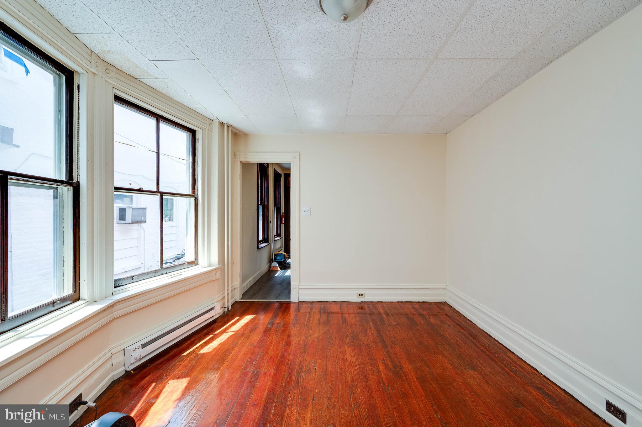 1032 North 5th Street Reading, PA 19601 - Photo 10 of 45 a view of empty room with wooden floor and fan