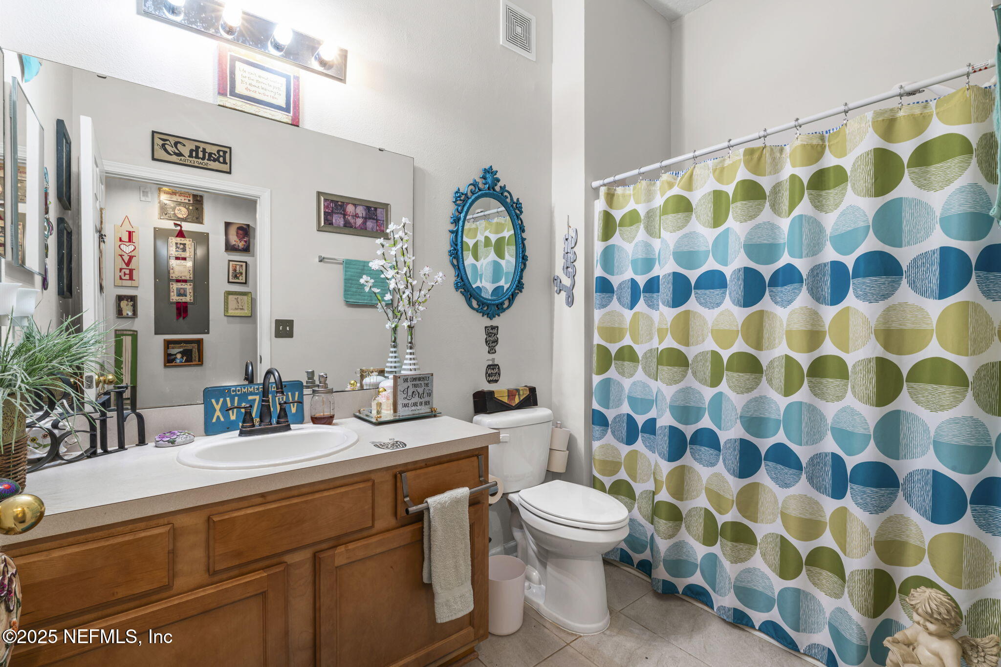 7920 Merrill Road, Unit 1206 Jacksonville, FL 32277 - Photo 11 of 35 a bathroom with a toilet sink and mirror