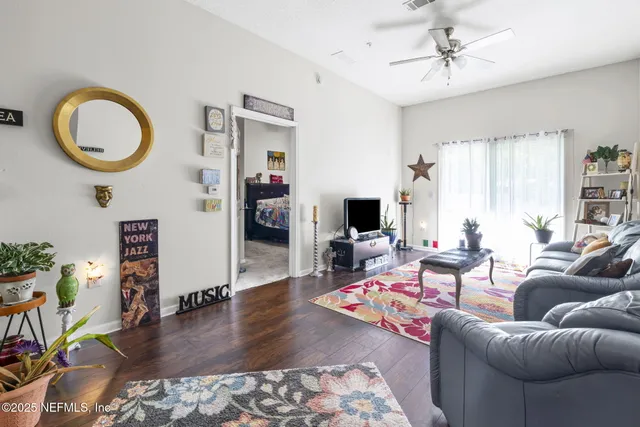 a living room with furniture and flowers