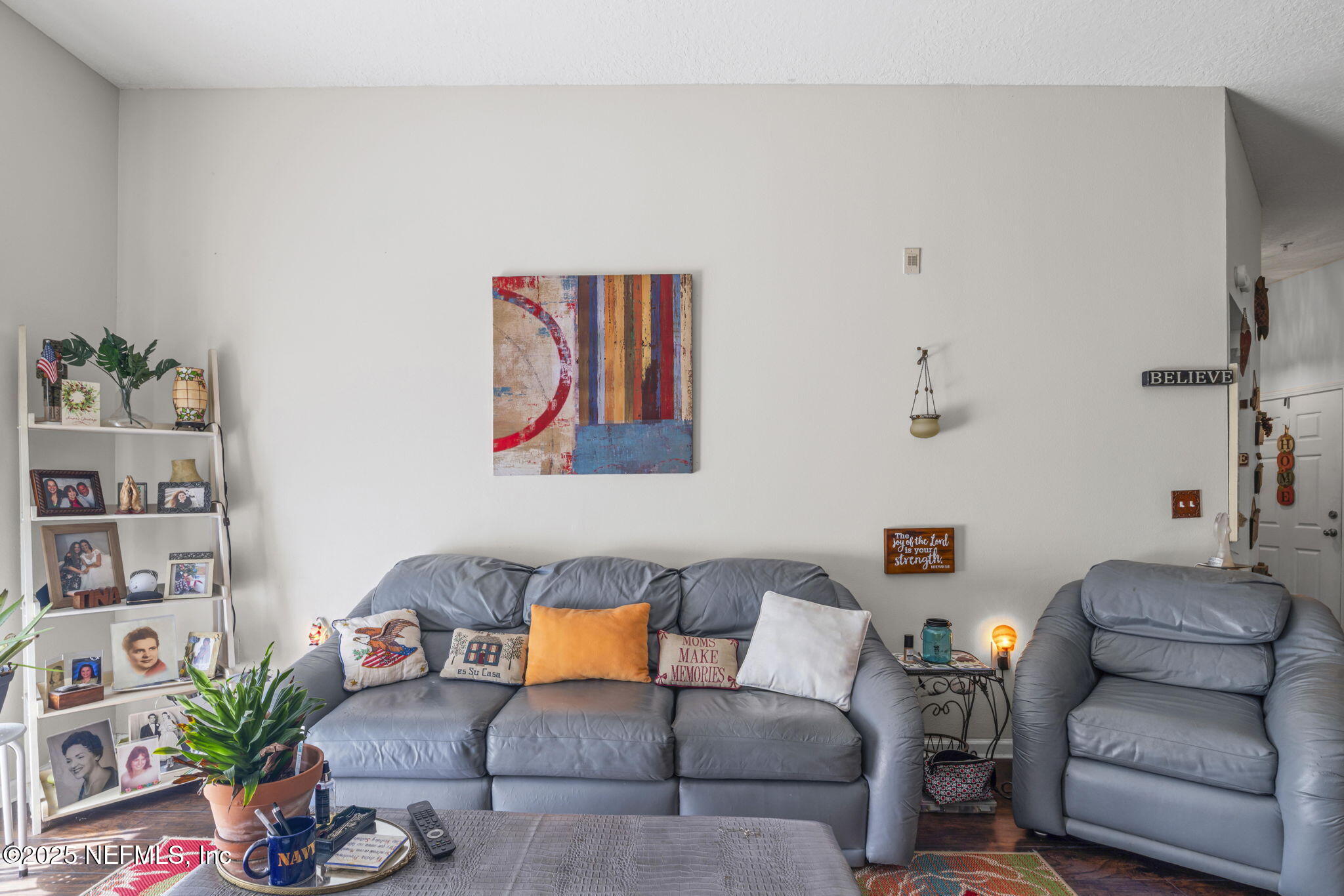7920 Merrill Road, Unit 1206 Jacksonville, FL 32277 - Photo 14 of 35 a living room with furniture and flowers