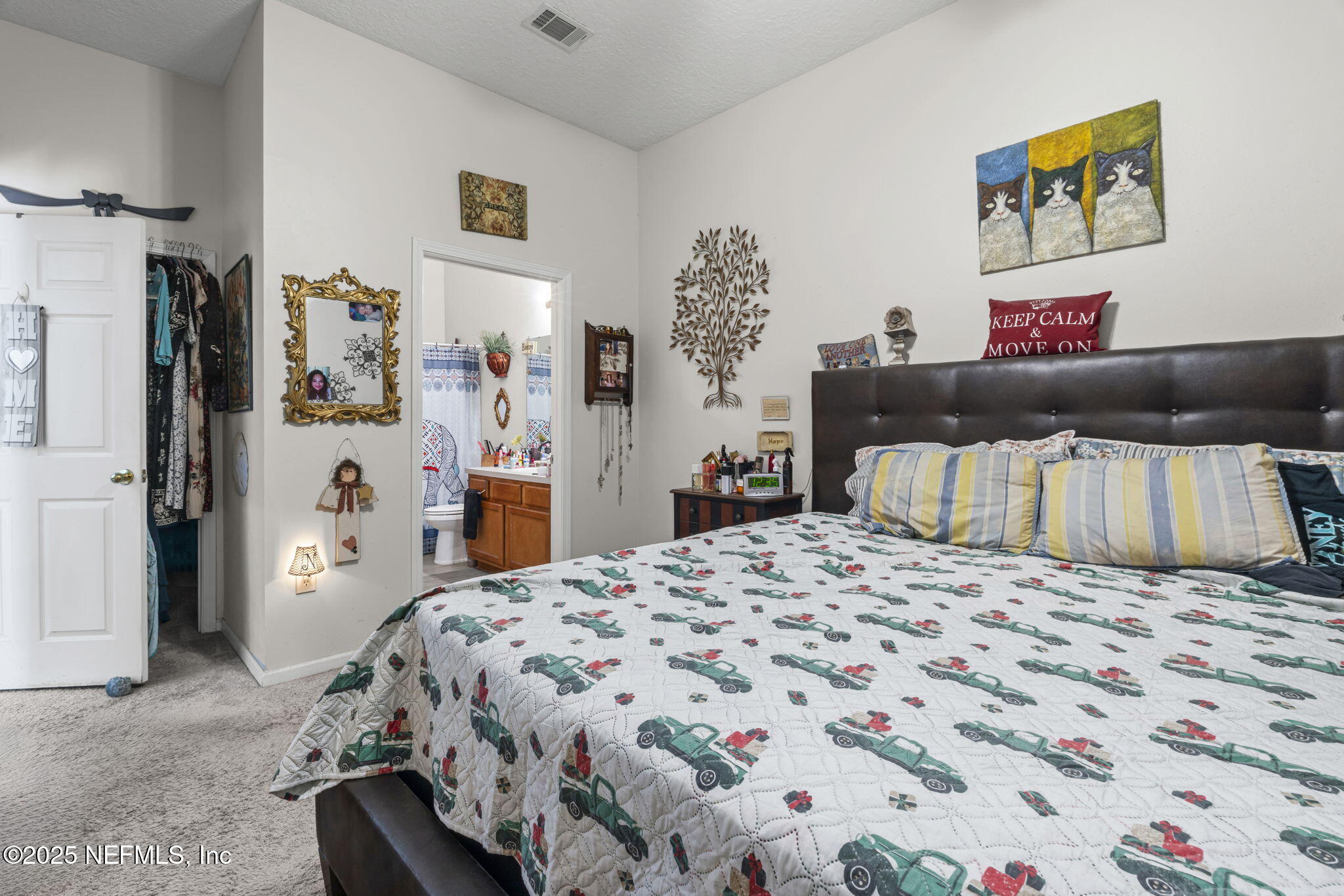 7920 Merrill Road, Unit 1206 Jacksonville, FL 32277 - Photo 18 of 35 a bedroom with a bed and a dresser