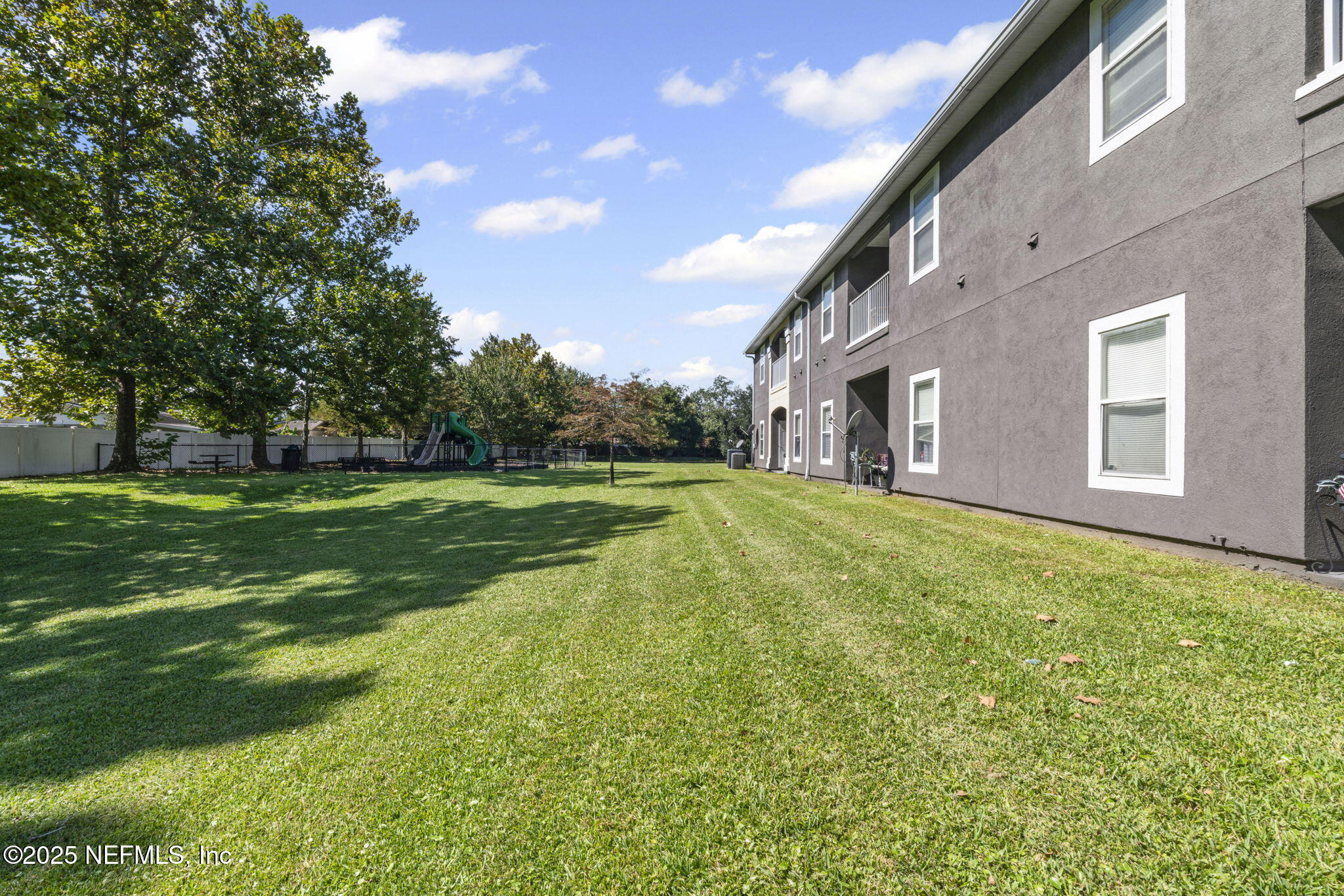 7920 Merrill Road, Unit 1206 Jacksonville, FL 32277 - Photo 21 of 35 a view of a house with a big yard