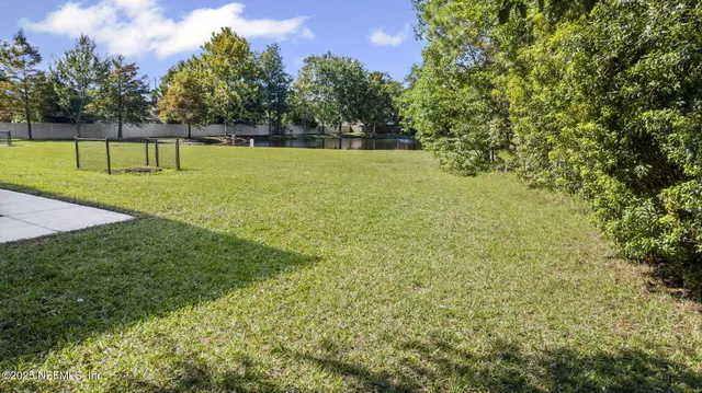 an aerial view of a house with yard swimming pool and outdoor seating