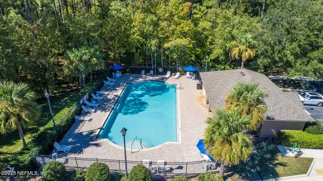 an aerial view of a house with a swimming pool