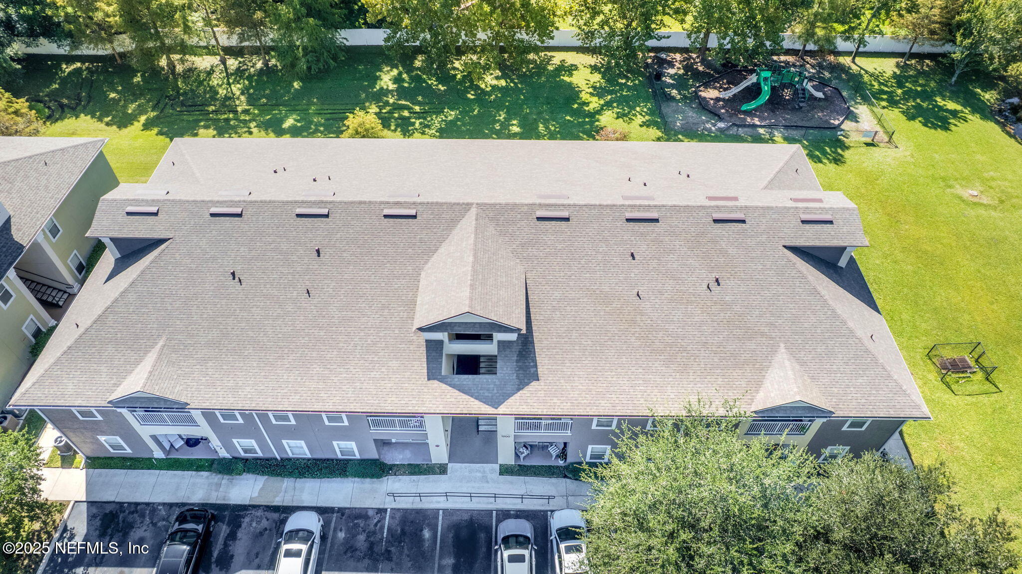 7920 Merrill Road, Unit 1206 Jacksonville, FL 32277 - Photo 31 of 35 an aerial view of a house with swimming pool and large trees