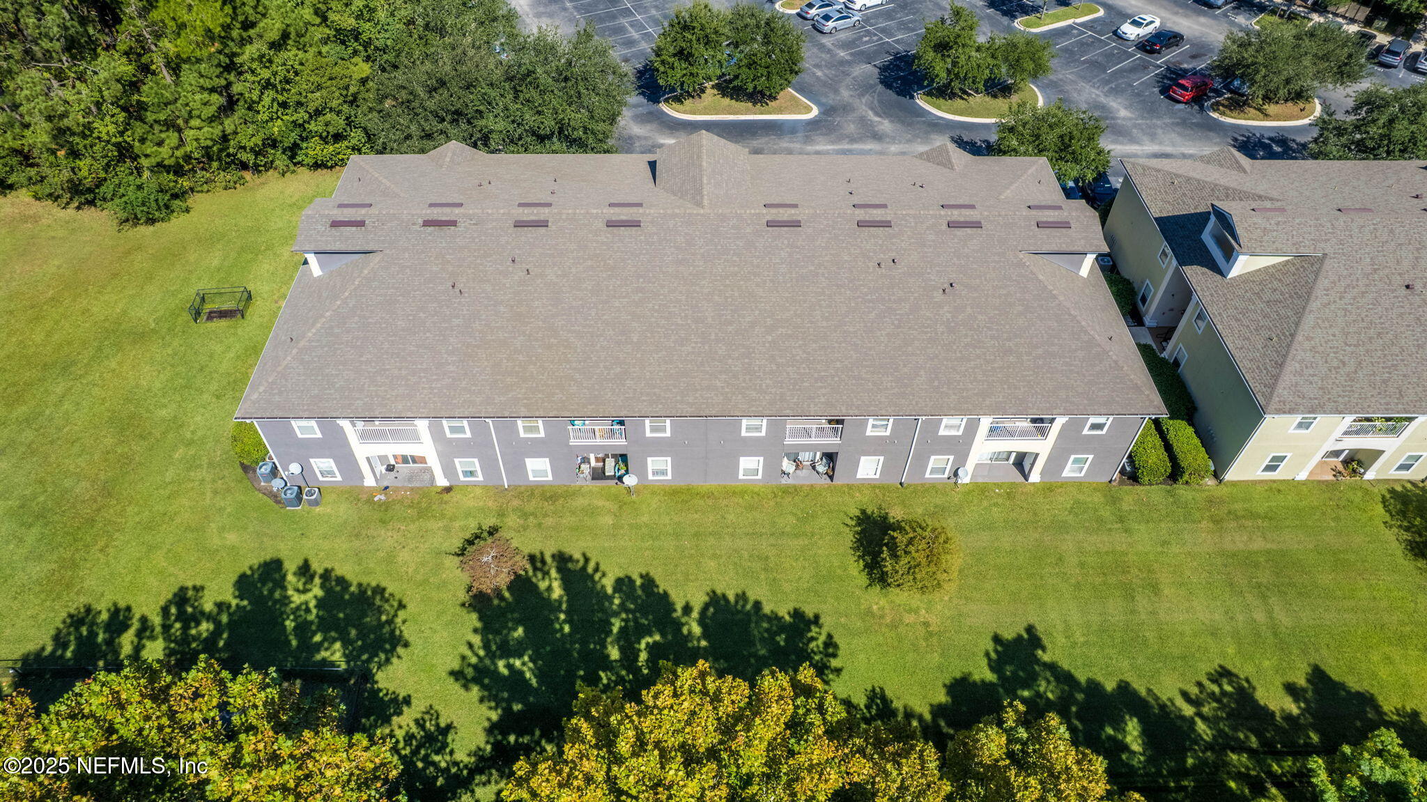 7920 Merrill Road, Unit 1206 Jacksonville, FL 32277 - Photo 33 of 35 an aerial view of residential houses with outdoor space and swimming pool