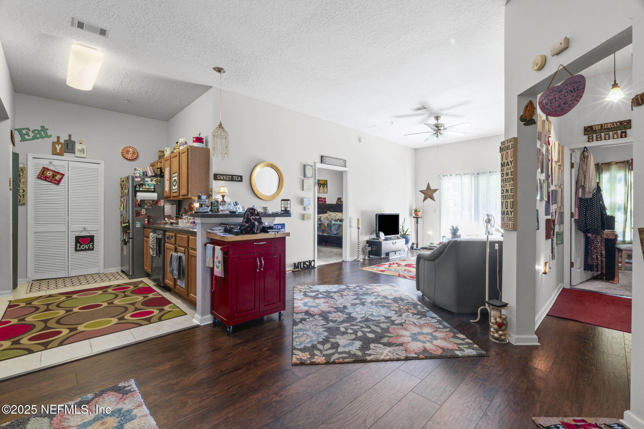 7920 Merrill Road, Unit 1206 Jacksonville, FL 32277 - Photo 6 of 35 a kitchen with stainless steel appliances granite countertop a stove refrigerator and a wooden floor