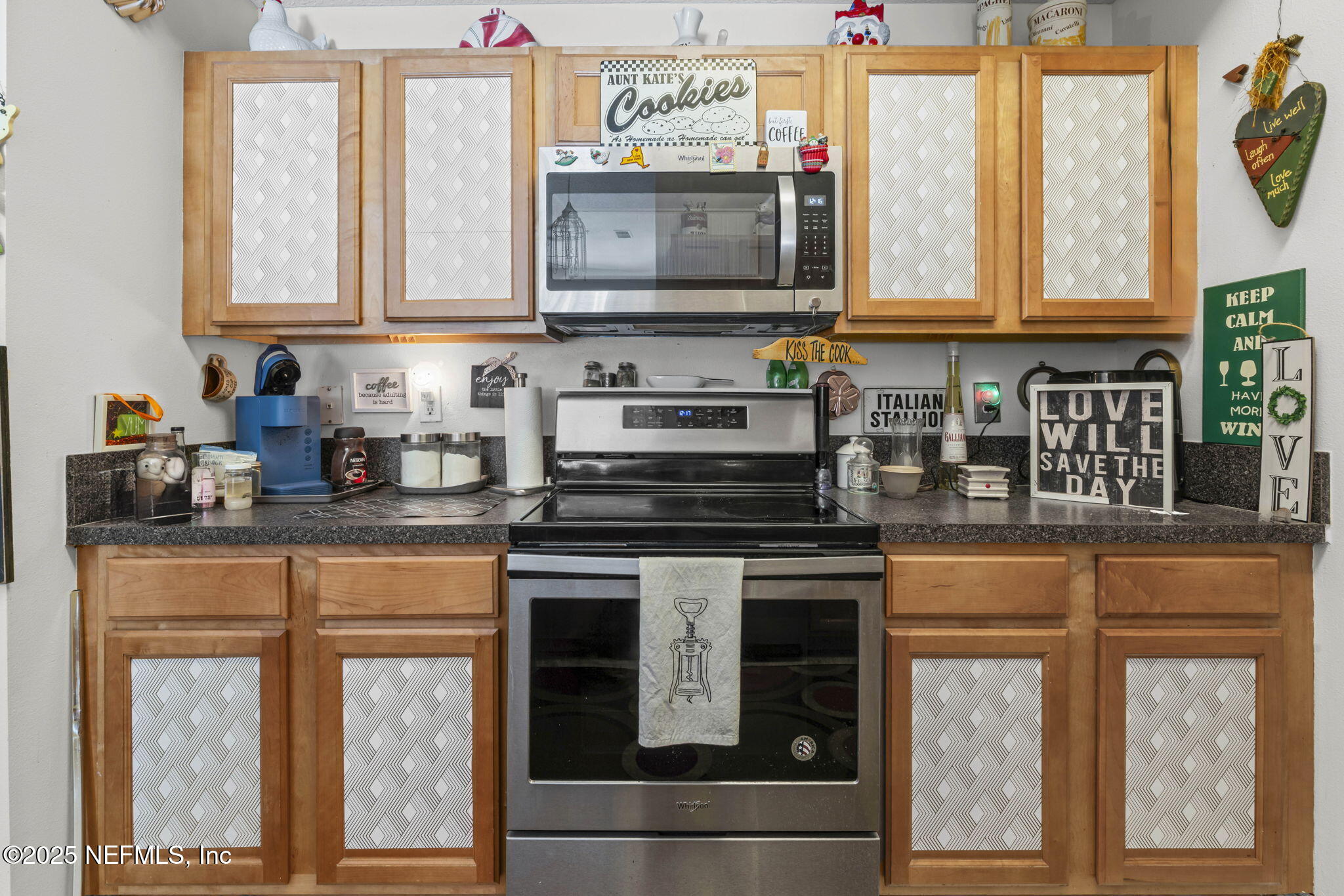 7920 Merrill Road, Unit 1206 Jacksonville, FL 32277 - Photo 8 of 35 a kitchen with stainless steel appliances granite countertop a stove and a microwave