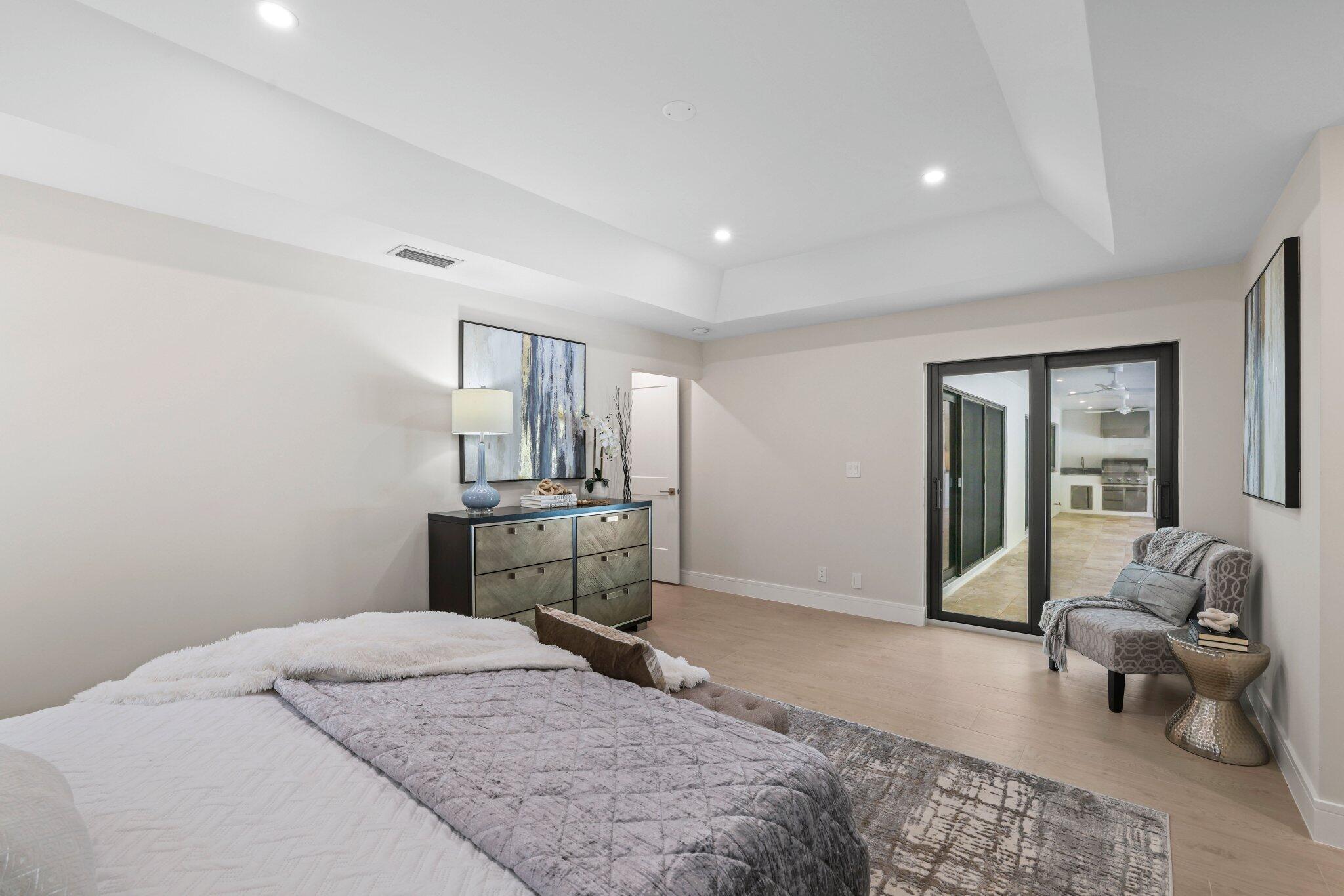 3901 Northwest 27th Avenue Boca Raton, FL 33434 - Photo 31 of 56 a bedroom with a bed and wooden floor
