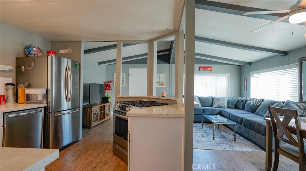 5200 Heil Avenue, Unit 18 Huntington Beach, CA 92649 - Photo 5 of 21 a kitchen with stainless steel appliances granite countertop a refrigerator a stove and a refrigerator