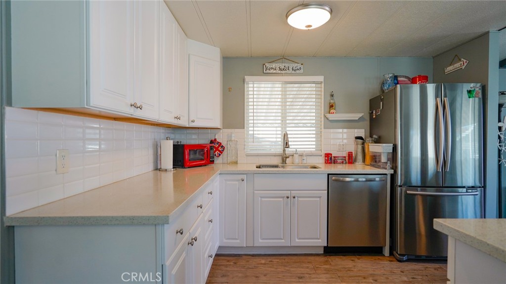 5200 Heil Avenue, Unit 18 Huntington Beach, CA 92649 - Photo 10 of 21 a kitchen with a sink a refrigerator and window