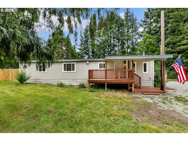 a view of a house with backyard and sitting area