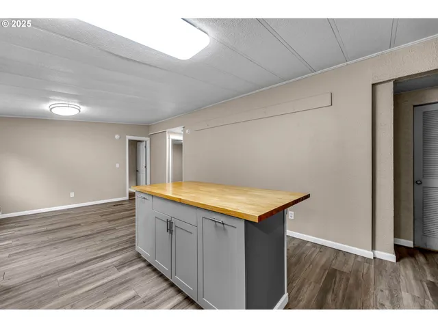 a kitchen with kitchen island a sink and wooden floor