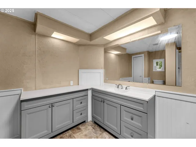 a bathroom with a sink and a mirror