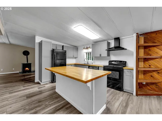 a kitchen with stainless steel appliances granite countertop a stove and a refrigerator