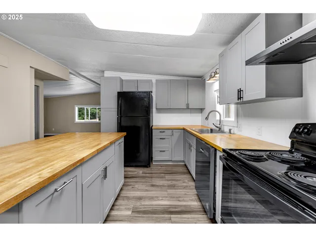 a kitchen with sink cabinets and wooden floor