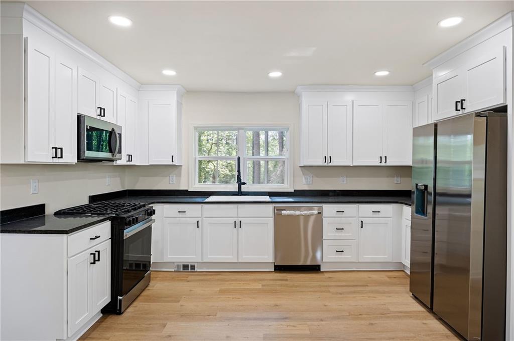 4289 Kimball Road Southwest Atlanta, GA 30331 - Photo 5 of 20 a kitchen with stainless steel appliances granite countertop a stove a sink and a refrigerator