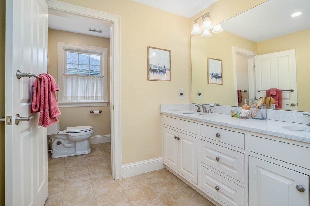 19 Lyon Road Brookline, MA 02467 - Photo 25 of 41 a bathroom with a granite countertop toilet sink and mirror