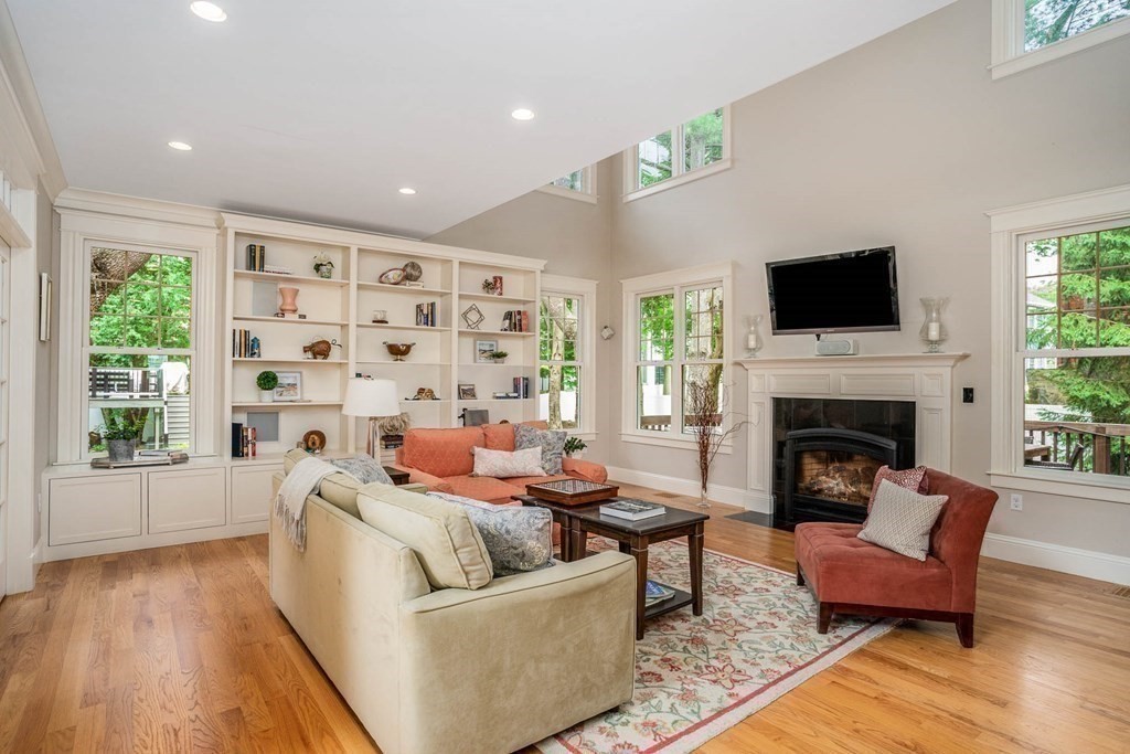 19 Lyon Road Brookline, MA 02467 - Photo 8 of 41 a living room with furniture a flat screen tv and a fireplace