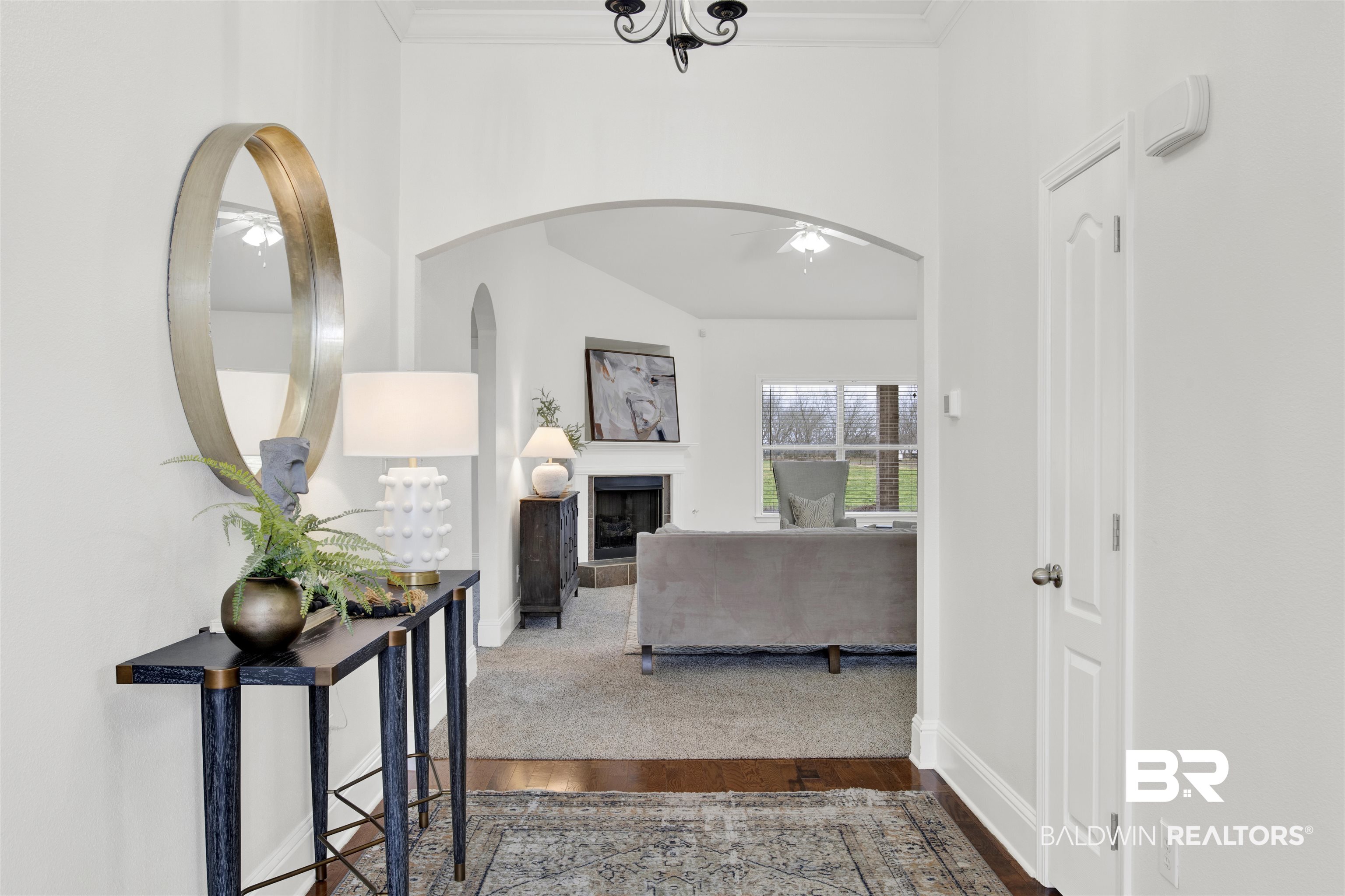 25350 Spindle Lane Daphne, AL 36526 - Photo 5 of 32 Hallway with crown molding and hardwood / wood-style flooring