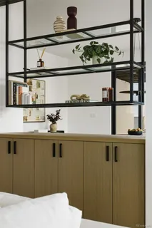 a bedroom with a bed and a white cabinet
