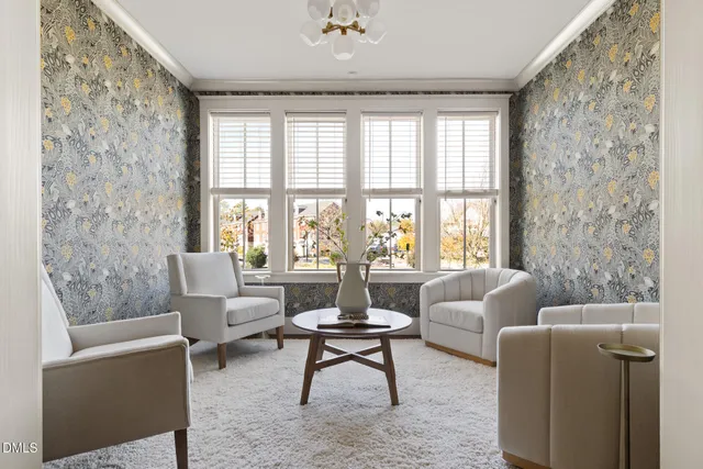 a living room with furniture and a chandelier