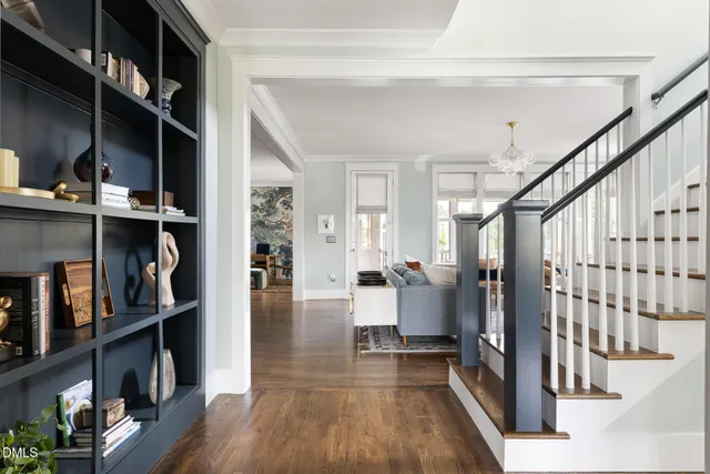 a kitchen with stainless steel appliances a kitchen island hardwood floor and a sink