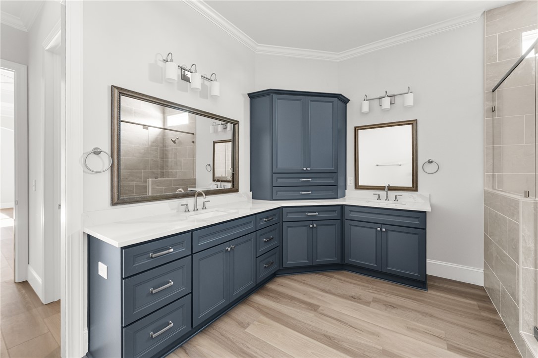 141 Rickys Path Easley, SC 29642 - Photo 23 of 40 This spacious bathroom offers elegant dual vanities and a modern shower for daily rejuvenation.