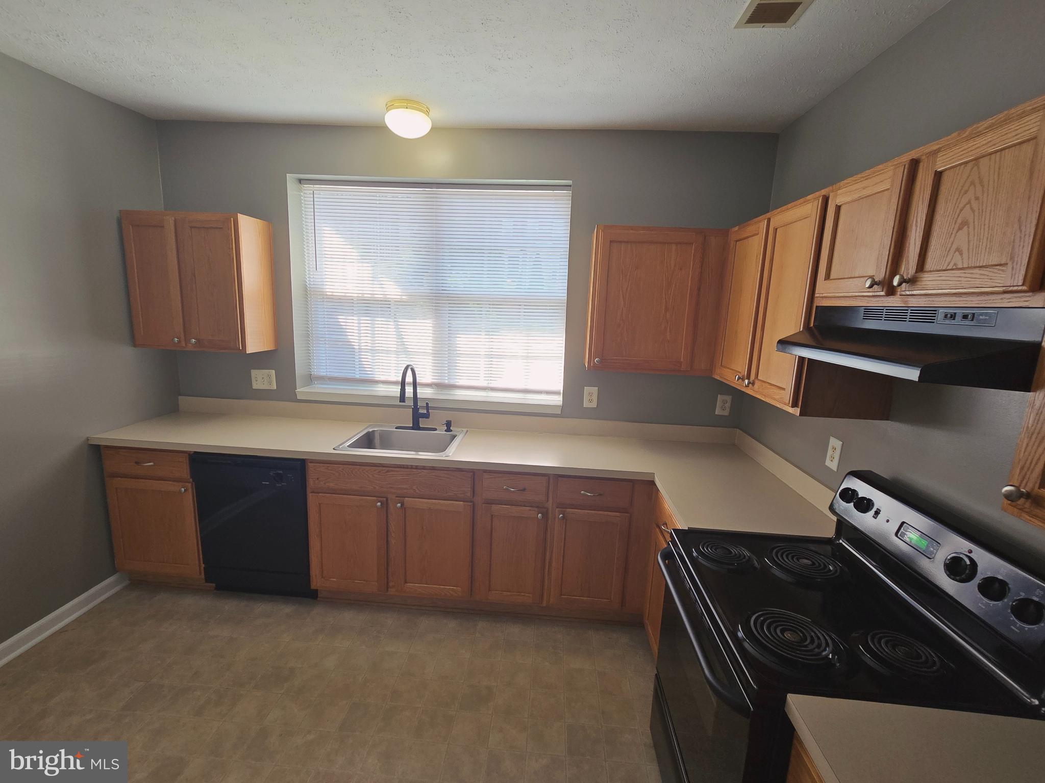 118 Heather Stone Way, Unit 80 Glen Burnie, MD 21061 - Photo 12 of 27 a kitchen with stainless steel appliances granite countertop a sink stove and cabinets