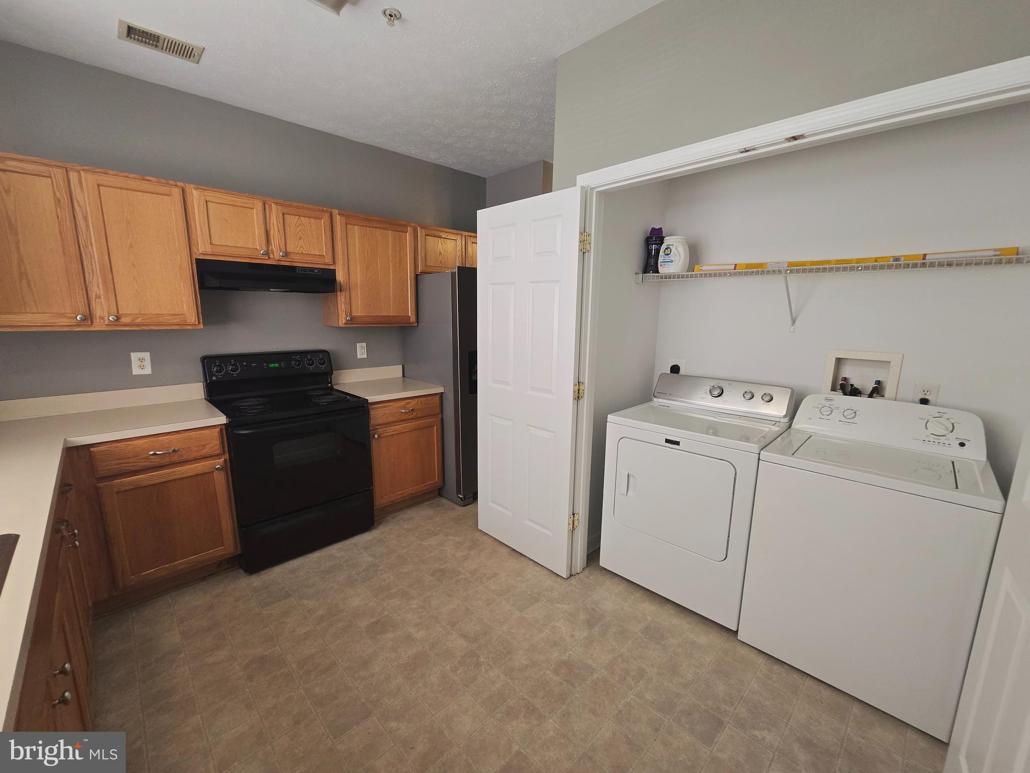 118 Heather Stone Way, Unit 80 Glen Burnie, MD 21061 - Photo 13 of 27 a kitchen with a refrigerator sink and cabinets