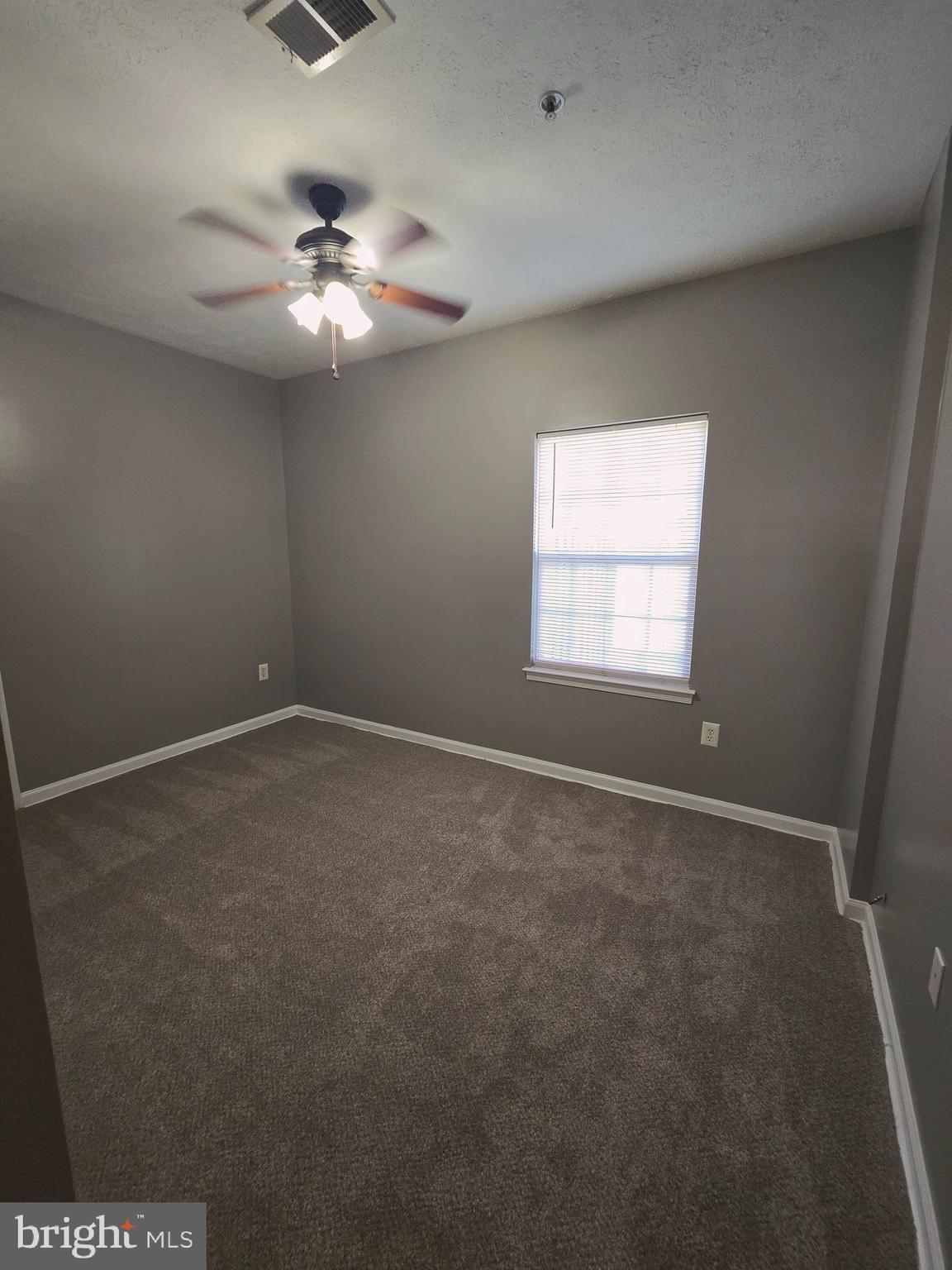 118 Heather Stone Way, Unit 80 Glen Burnie, MD 21061 - Photo 15 of 27 an empty room with windows and fan