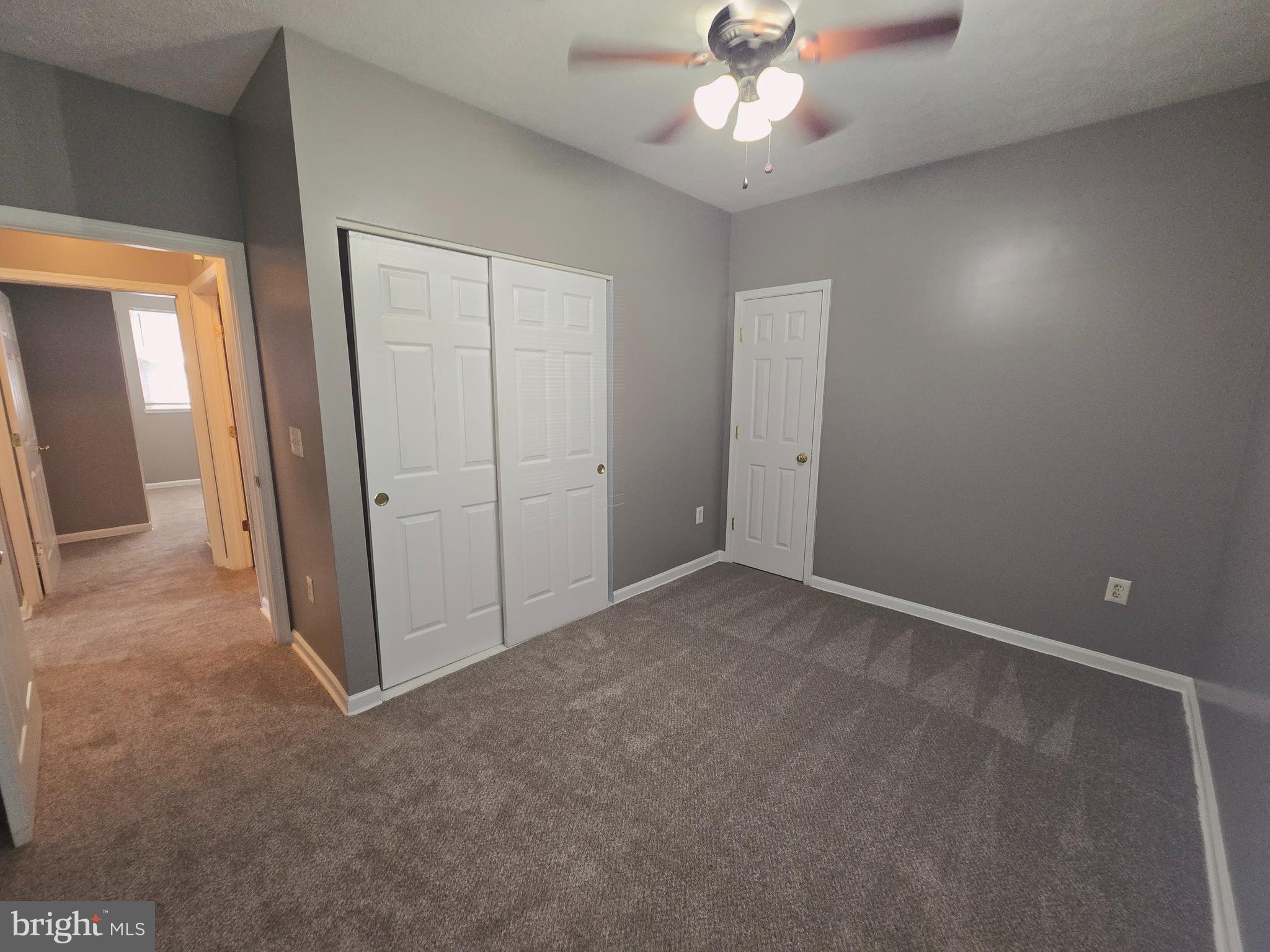 118 Heather Stone Way, Unit 80 Glen Burnie, MD 21061 - Photo 16 of 27 an empty room with fan and entrance