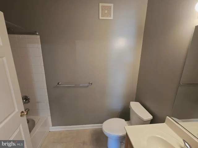 a bathroom with a shower and toilet