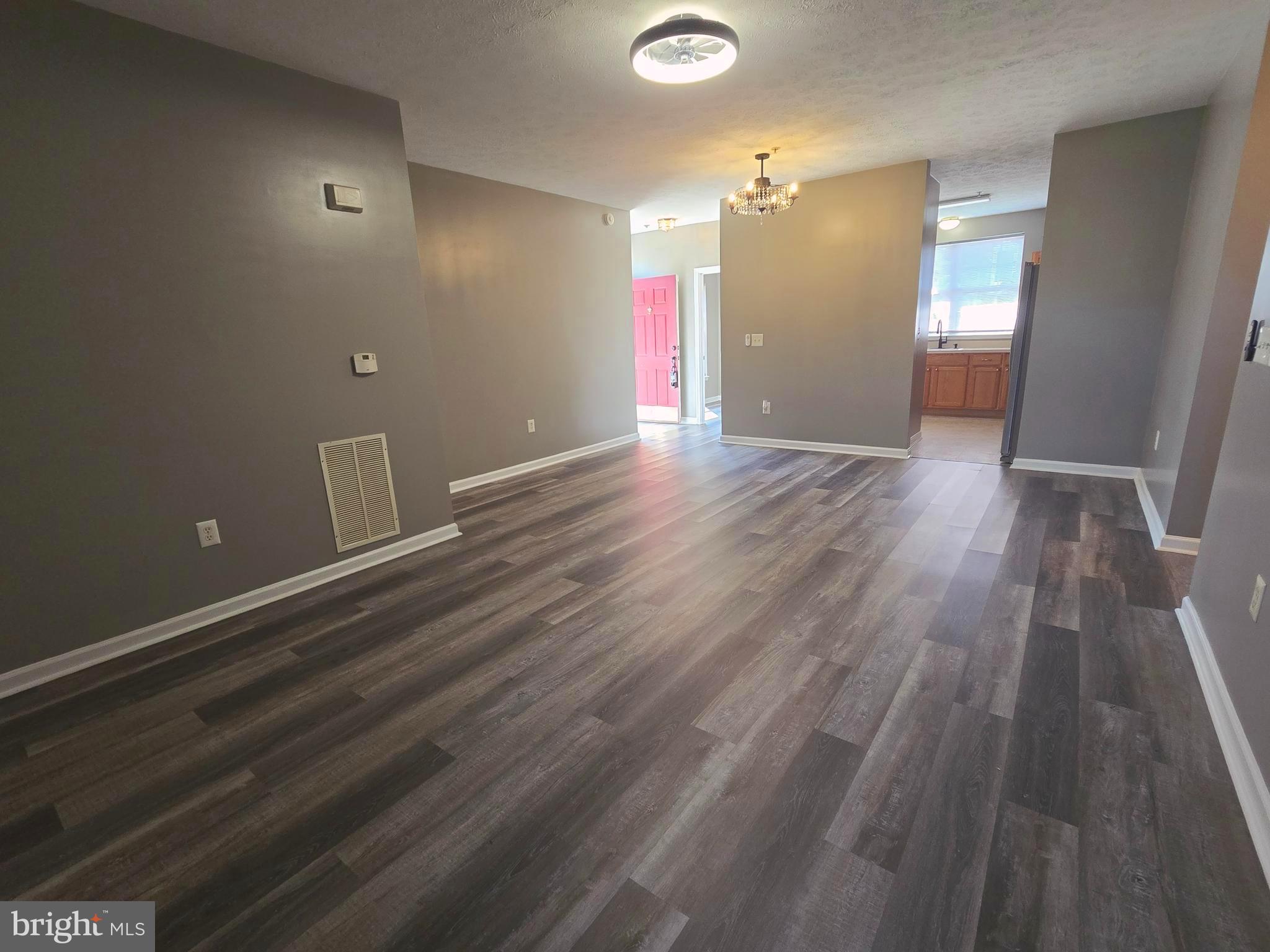 118 Heather Stone Way, Unit 80 Glen Burnie, MD 21061 - Photo 2 of 27 a view of an empty room with wooden floor and a window