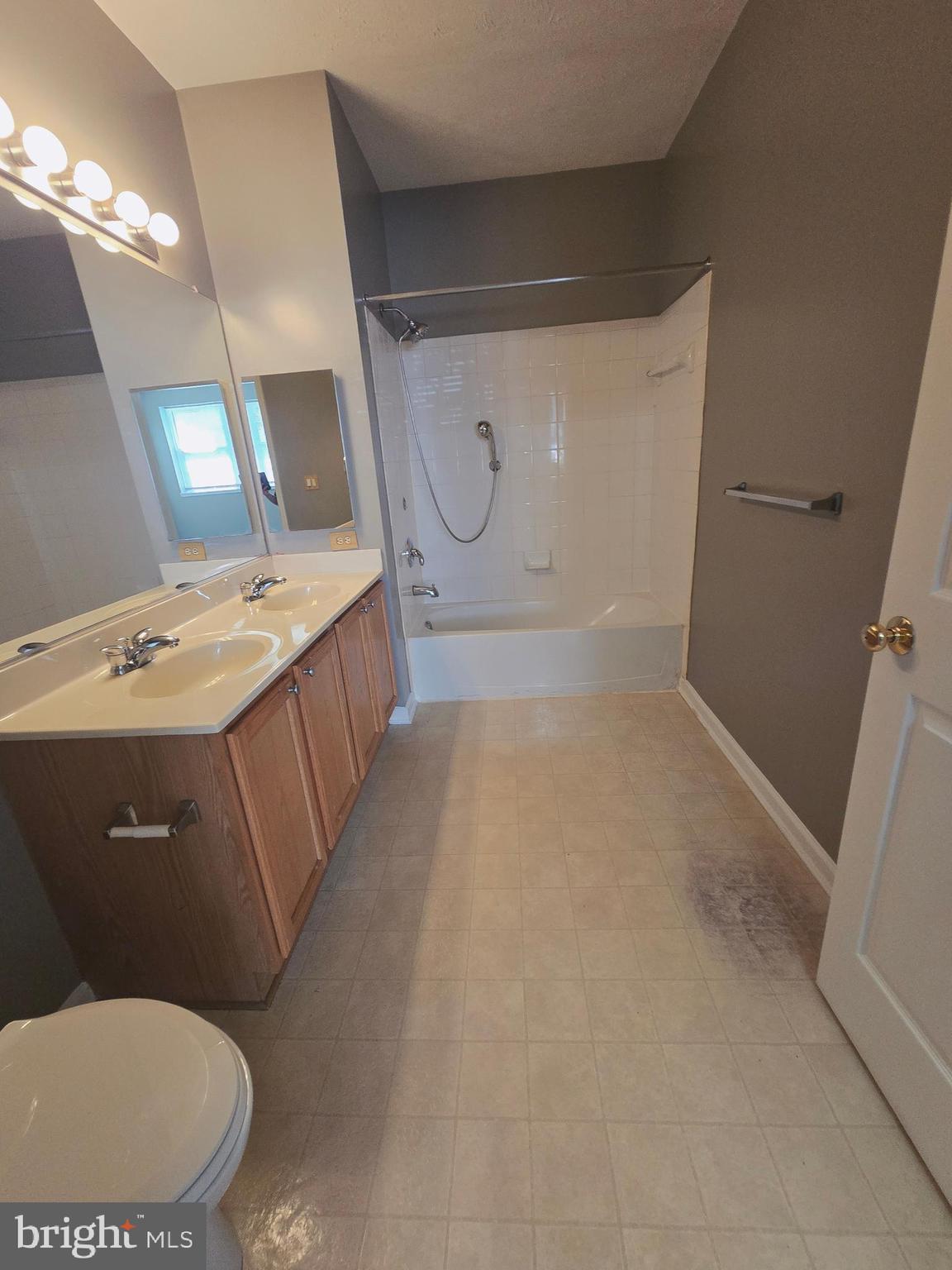 118 Heather Stone Way, Unit 80 Glen Burnie, MD 21061 - Photo 22 of 27 a bathroom with a sink a toilet and mirror