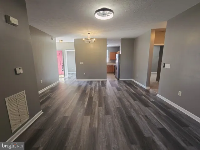 a view of hallway with wooden floor