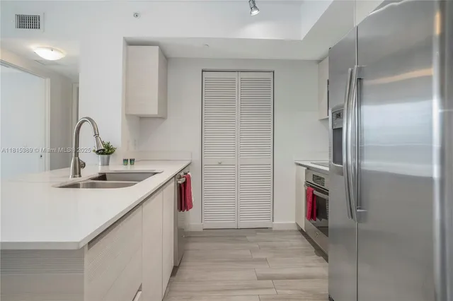 a kitchen with a sink and a refrigerator