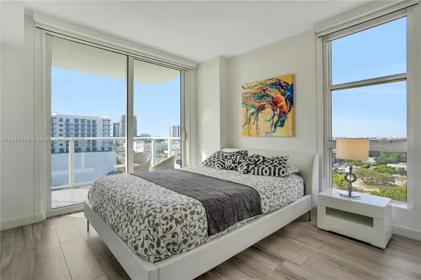 a bedroom with a large bed and a large window