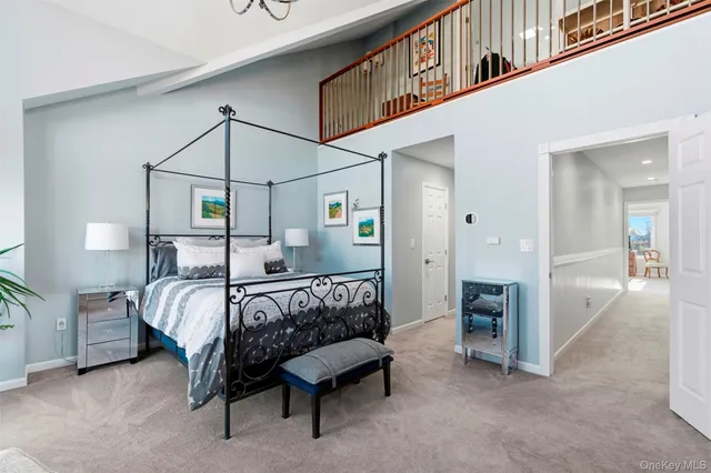 a bedroom with bed and a chandelier