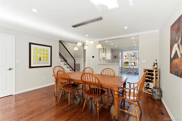 a dining room with furniture and wooden floor