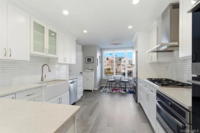 a kitchen with sink stove and cabinets