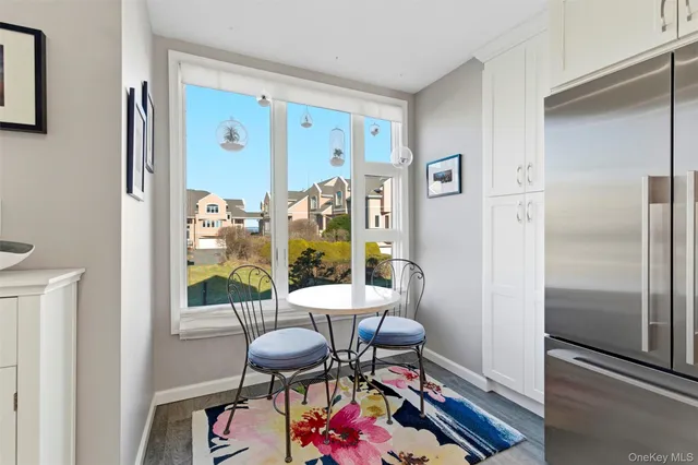 a view of a dining room with furniture one side kitchen view and a refrigerator