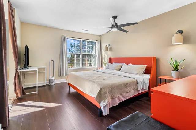 a bedroom with a bed and a flat screen tv